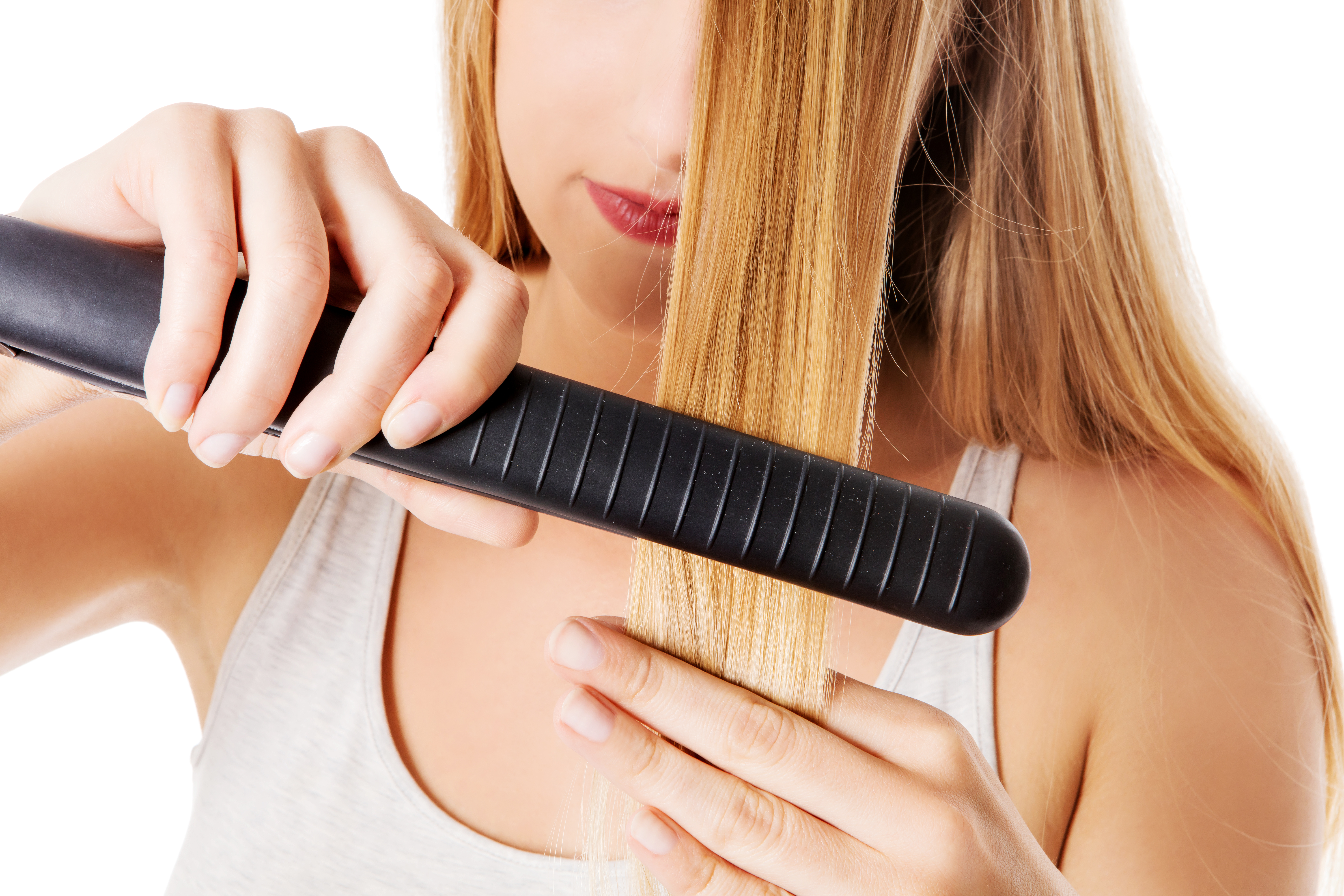 Woman using hair straighteners