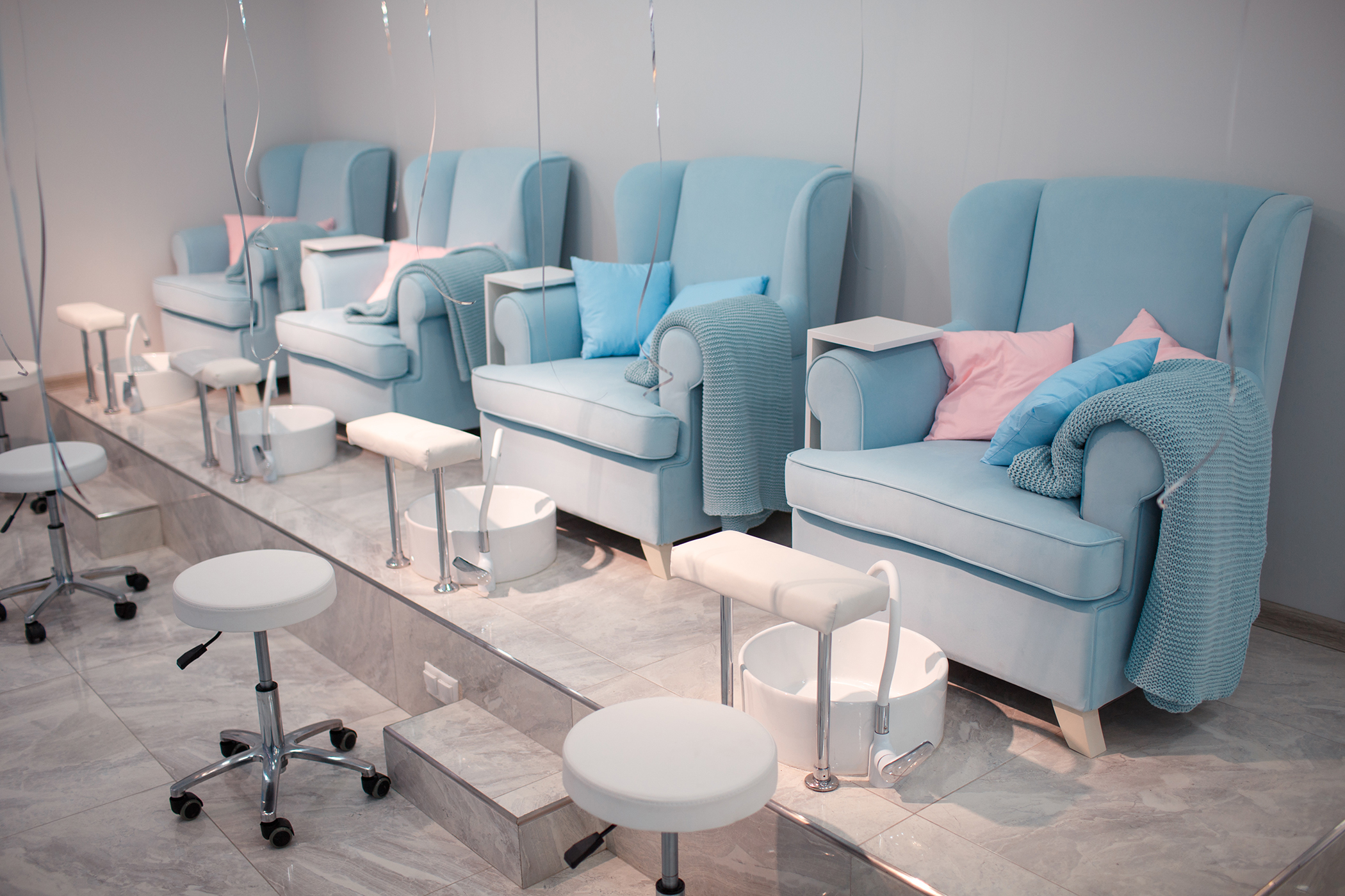 beauty salon with blue chairs for pedicure