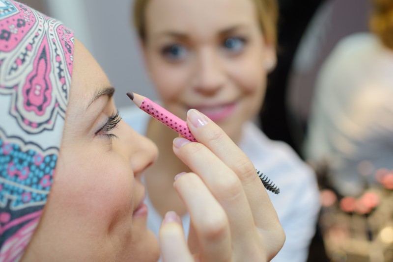 Cancer patient having eyebrows applied by beaut therapist