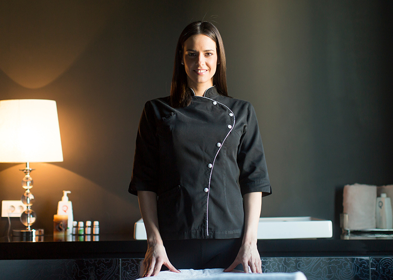 Beauty therapist wearing black in salon treatment room