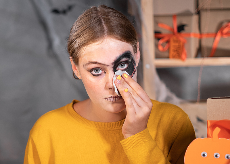 Woman removing halloween makeup